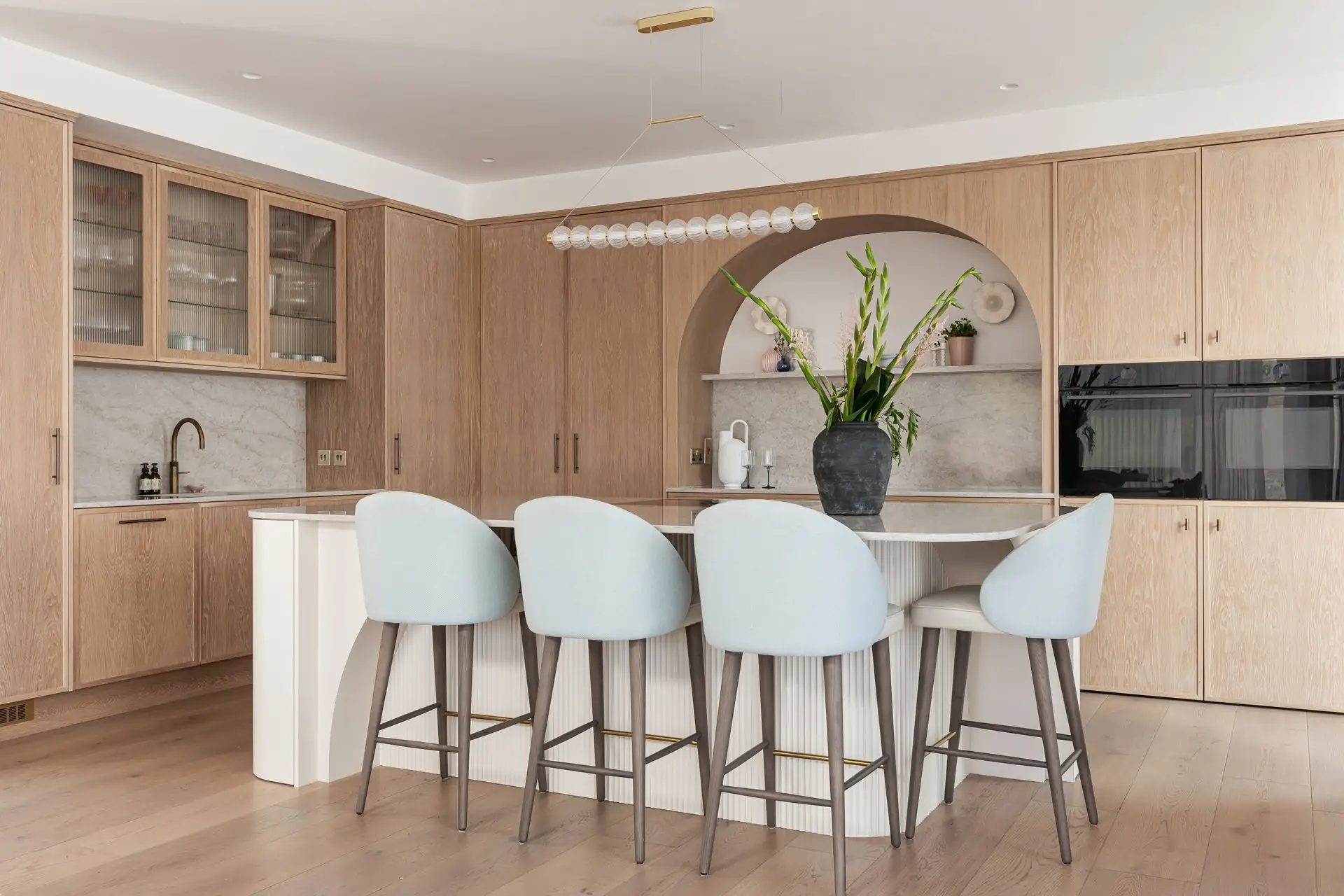 Light Oak Micro Shaker Kitchen with Glencoe Quartz Island and Soft Blue Bar Stools Dorans